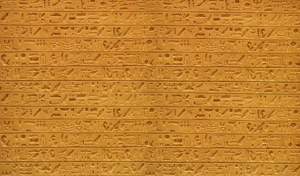 Closeup of old Egyptian hieroglyphs carved on stone