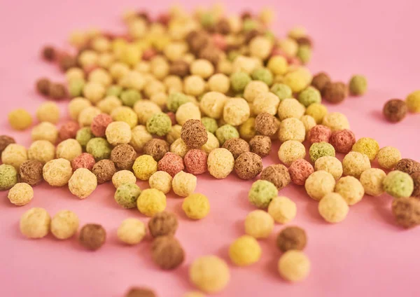 Cornflakes or cereal on pink background
