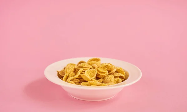 White Plate Beige Cornflakes Pink Background — Stock Photo, Image