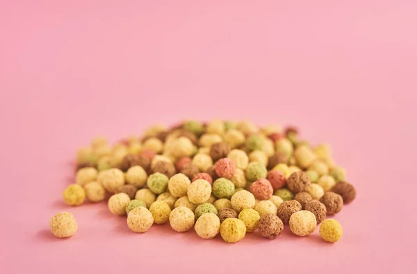 Cornflakes or cereal on pink background