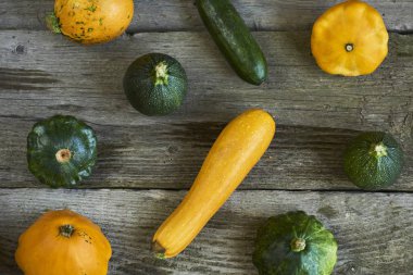 Dekoratif Güz pumpkins ve ahşap arka plan üzerinde taze squashes görüntüsünü