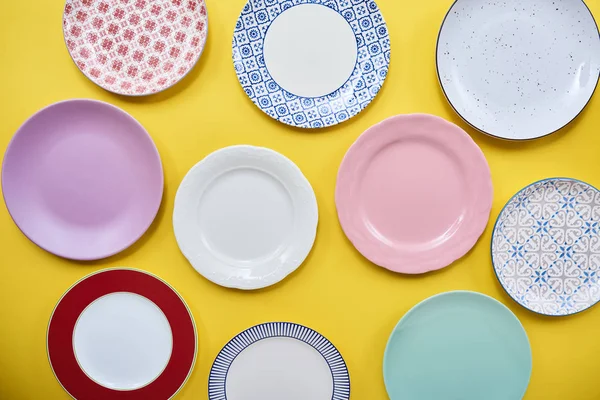 Set of different colorful dishes over bright colored background