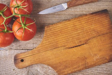 Fresh raw tomatoes over wooden background