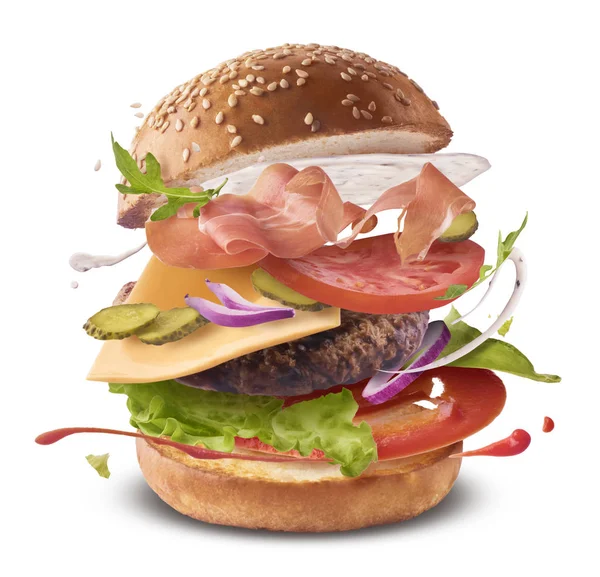 Delicious burger with flying ingredients isolate — Zdjęcie stockowe