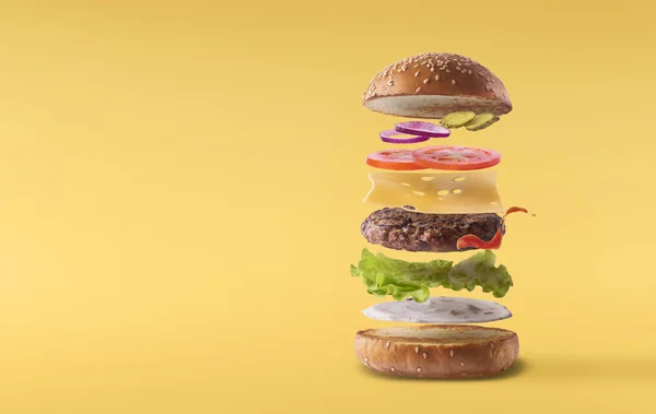 Delicious burger with flying ingredients isolated