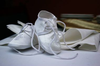 Newborn baby shoes, elegant, white colored clipart