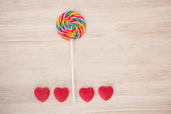 Landscape formed with a lollipop and heart candies — Stock Photo, Image