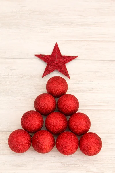 Christmas decorations arranged in tree shape — Stock Photo, Image