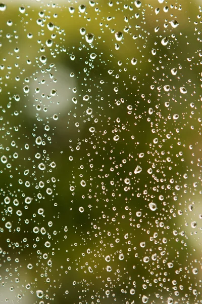 Glass with drops of rain water — Stock Photo, Image