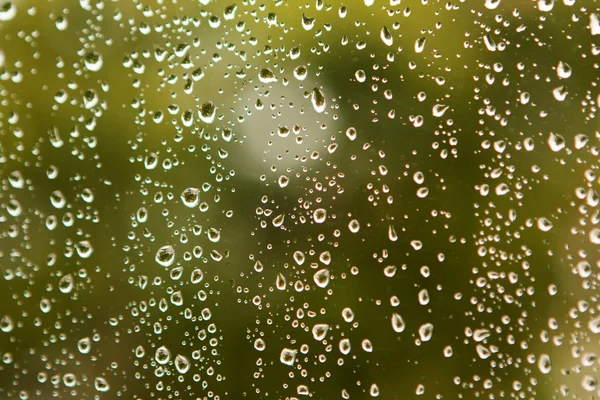 Glass with drops of rain water — Stock Photo, Image