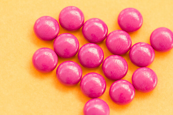 Red pills on orange background