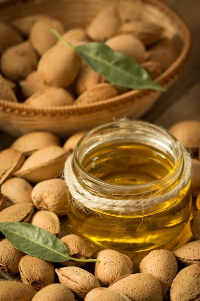 Almond oil and almonds — Stock Photo, Image