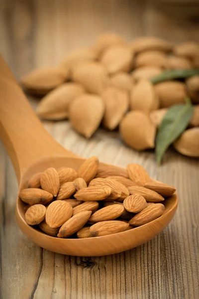 Almond seeds on wooden table — Φωτογραφία Αρχείου