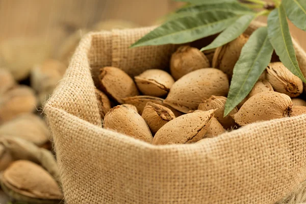 Almond seeds on wooden table — Φωτογραφία Αρχείου