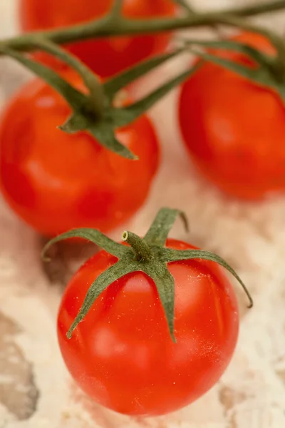 Cherry tomatoes on table with flour — ストック写真