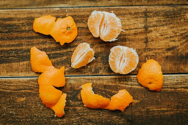 Peeled tangerine on wooden table — Stock Photo, Image