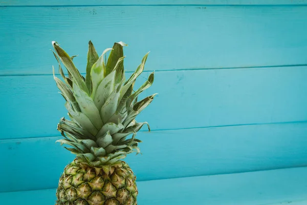 Pineapple on blue wooden table — Stock Photo, Image