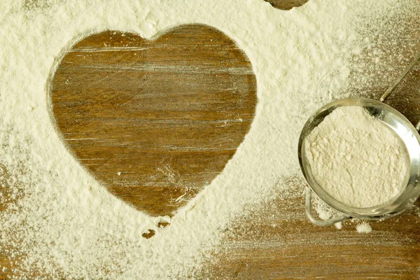 Heart shape in sifted flour — Stock Photo, Image