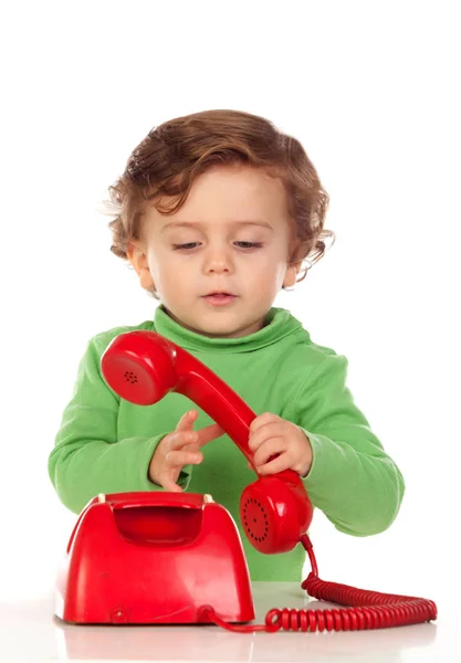 Хлопчик з червоним телефоном — стокове фото