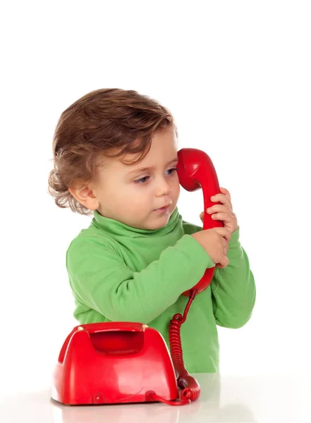 Хлопчик з червоним телефоном — стокове фото