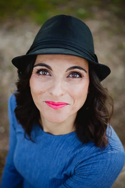 Stylish young woman with black hat — Stock Photo, Image