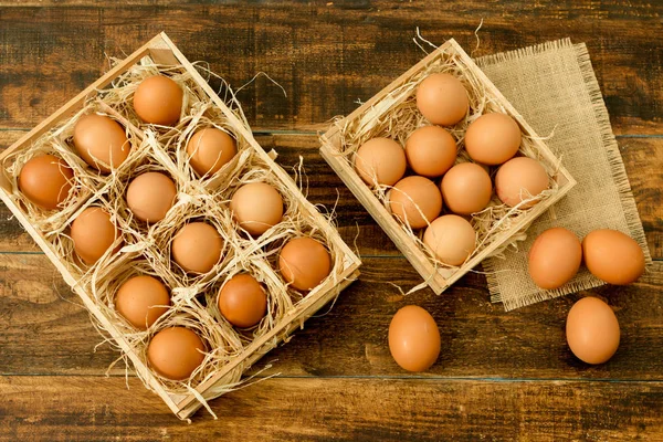 Raw eggs in wooden boxes — Stock Photo, Image