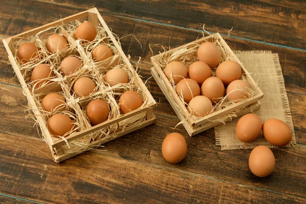 Raw eggs in wooden boxes — Stock Photo, Image
