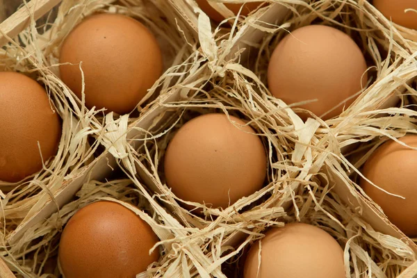 Raw eggs in wooden box — Stock Photo, Image