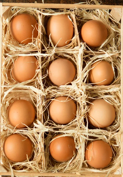 Raw eggs in wooden box — Stock Photo, Image