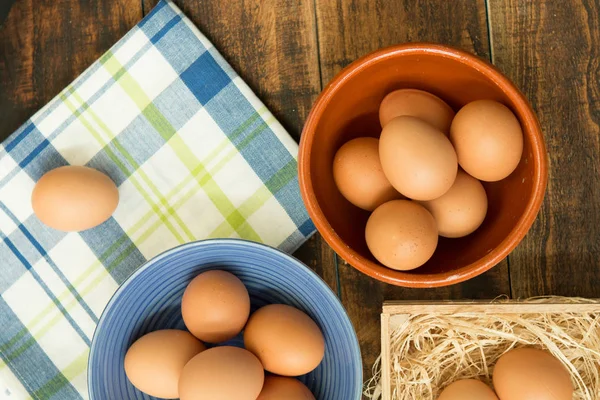 Raw eggs in bowls — Stock Photo, Image