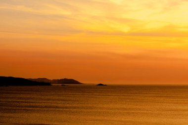 Denizin üzerinde turuncu gün batımı