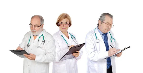 Mature doctors filling in reports Royalty Free Stock Photos