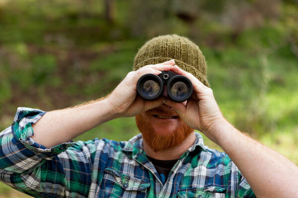 Young Man using binoculars