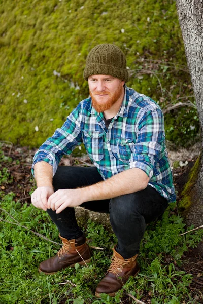 Red bearded man in plaid shirt