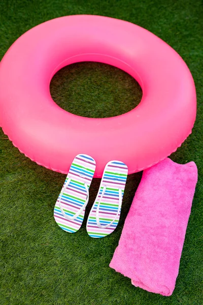 Pink lifebuoy colorful flip-flops and ball — Stock Photo, Image