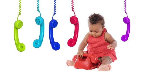 可爱的非洲婴儿玩老式手机和许多五颜六色的手机挂在白色背景隔离 — 图库照片