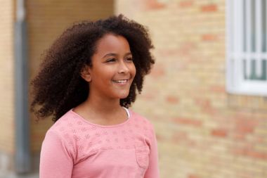Sokağın ortasında gülümseyen sevimli Afro-Amerikan kız