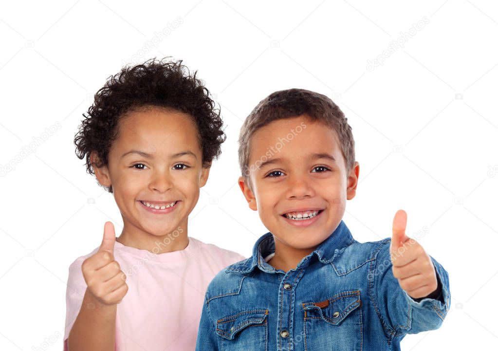 portrait of two cute little boys showing thumbs up isolated on white background