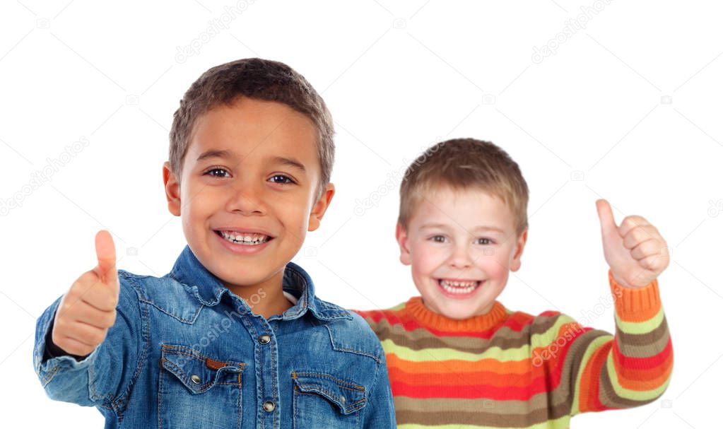 portrait of two cute little boys showing thumbs up isolated on white background