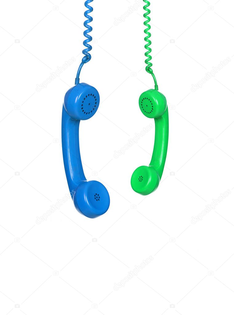 two bright vintage telephone handsets hanging isolated on white background