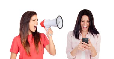 woman with megaphone shouting at her friend with mobile phone isolated on white background