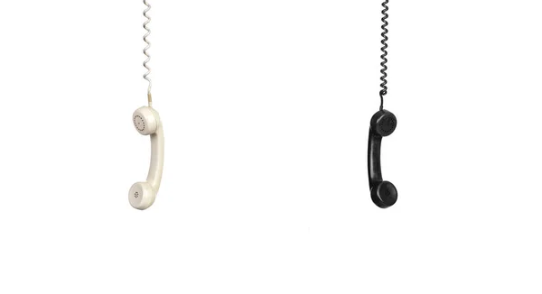 Dos teléfonos antiguos colgando de un cable — Foto de Stock