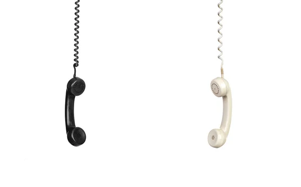 Two vintage phones hanging of a cable — Stock Photo, Image