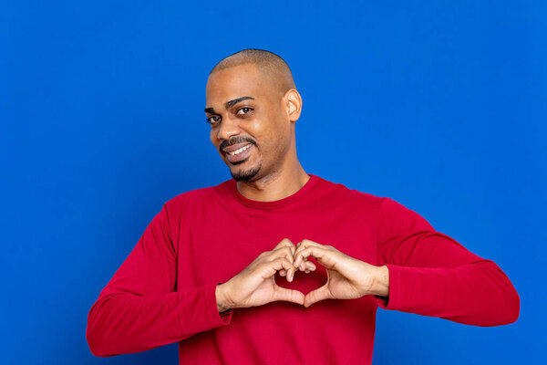 African guy with red jersey on a blue background
