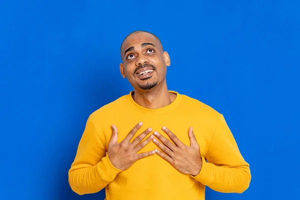 Chico Africano Con Una Camiseta Amarilla Sobre Fondo Azul —  Fotos de Stock