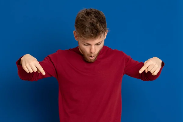 Atraktivní Mladý Muž Červeným Tričkem Modrém Pozadí — Stock fotografie