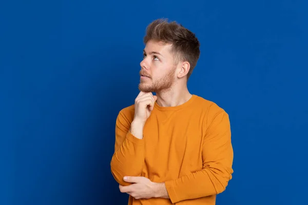 Attraktiver Junger Mann Mit Gelbem Shirt Auf Blauem Hintergrund — Stockfoto