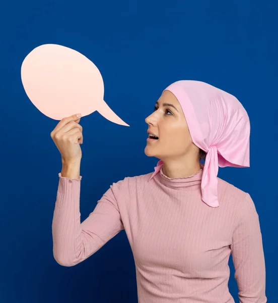 Young woman with pink scarf on the head on a blue background