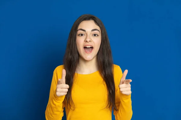 Chica Joven Morena Con Jersey Amarillo Sobre Fondo Azul — Foto de Stock