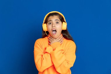 Adorable preteen girl with yellow jersey on a blue background clipart